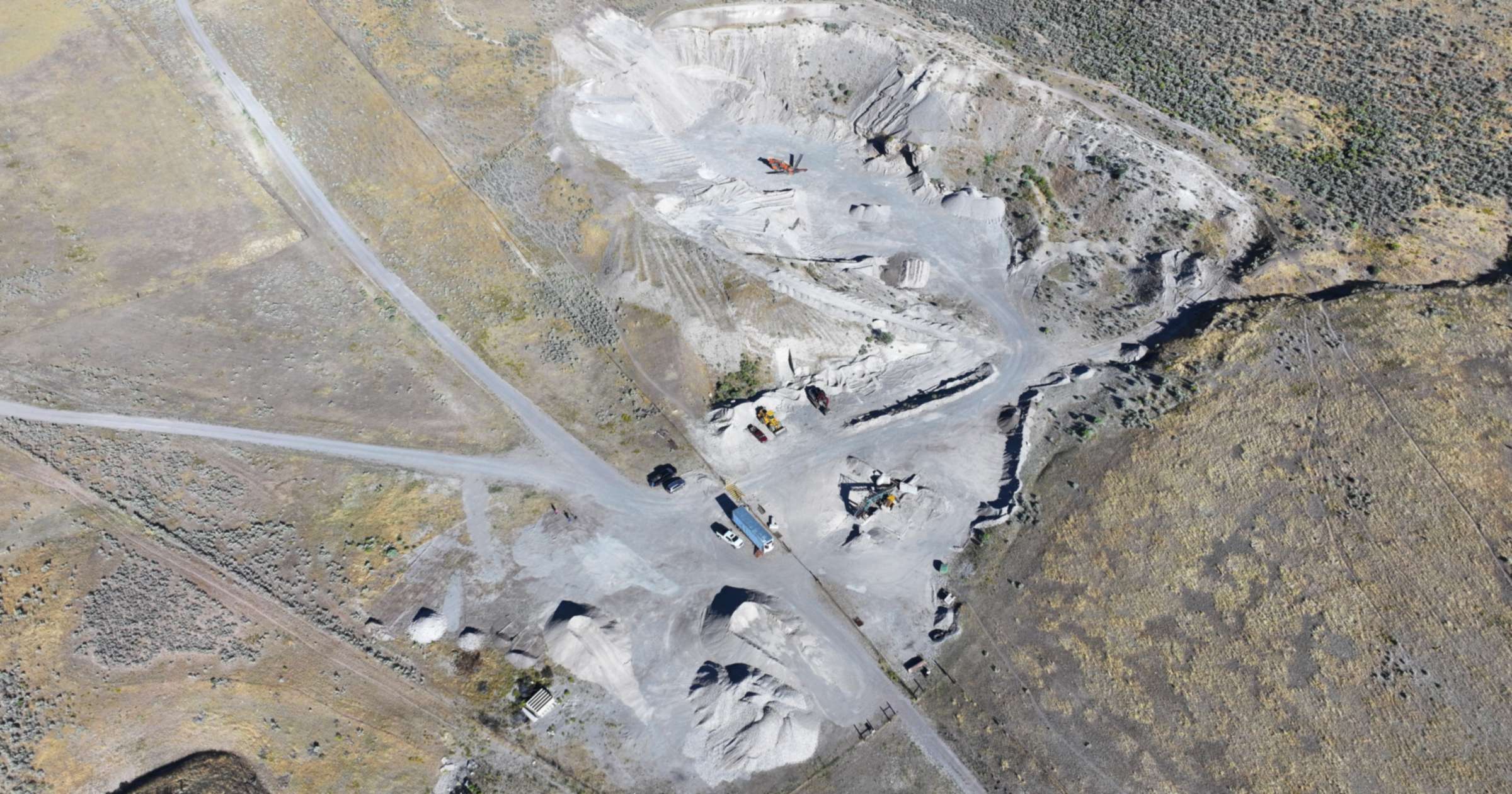 Aerial view of the J6 Rock gravel pit in Garland, Utah, surrounded by brown hills